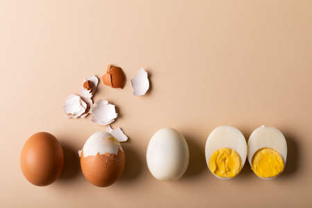Overhead view of fresh boiled brown and white eggs on pink background with copy space. unaltered, food, healthy eating and organic concept.の写真素材