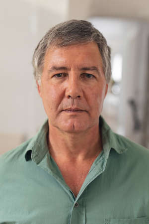 Close-up portrait of serious caucasian senior man at home. unaltered, lifestyle, domestic life and...