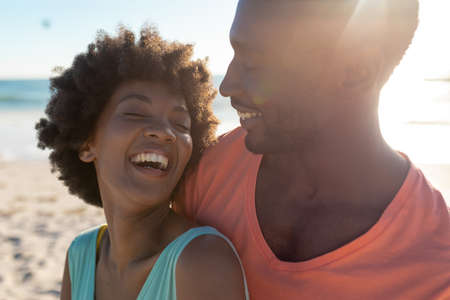 Happy african american couple enjoying summer holiday together at beach on sunny day. unaltered,...
