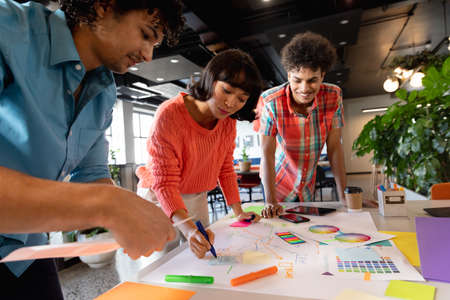 Creative multiracial colleagues planning strategy in meeting at office. Unaltered, teamwork,...
