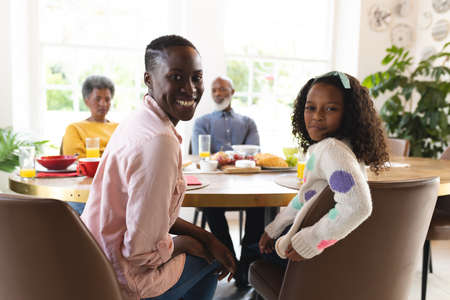 Image of happy multi generation african american family eating breakfast. Family and spending...