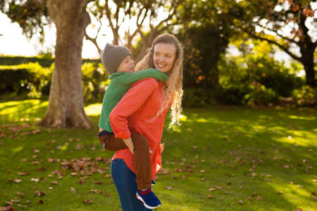 Image of happy caucasian mother and son in autumn garden. Family and spending quality time together...