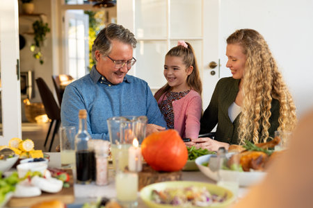 Image of multi generation caucasian family eating dinner together. Family and spending quality time together concept.の写真素材