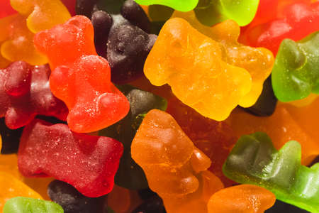 Close-up full frame shot of multi colored gummy bears pile. unaltered, unhealthy eating and sweet...