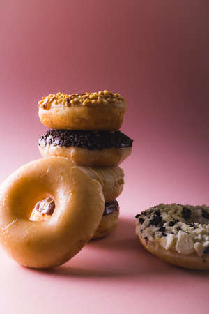 Close-up of fresh donuts stacked against copy space over colored background. unaltered, unhealthy eating and sweet food concept.の写真素材