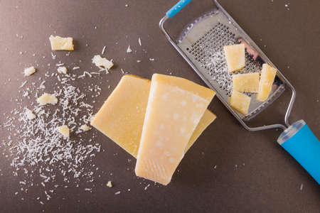 Directly above shot of cheese with grater on table, copy space. unaltered, food and dairy product.の写真素材