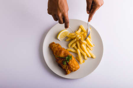 Cropped hands of african american man having french fries and seafood, copy space. unaltered, food, fried food, ready-to-eat, studio shot and meal.の写真素材