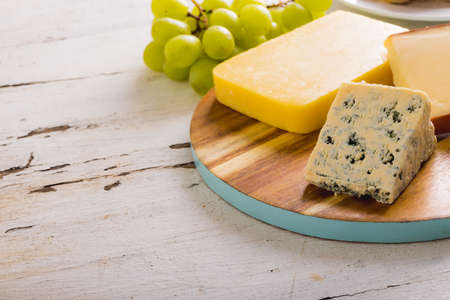 Close-up of various cheese with grapes on table, copy space. unaltered, food, fruit and dairy...