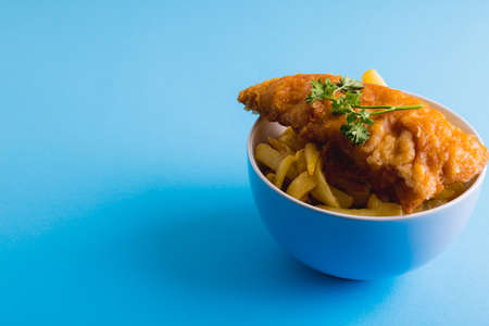 French fries with seafood in bowl on blue background, copy space. unaltered, food, fried food, ready-to-eat, studio shot and meal.の写真素材