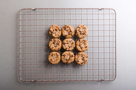 Directly above shot of fresh cookies on cooling rack at table, copy space. unaltered, food, preparation, still life.の写真素材