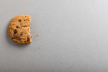 Directly above shot of half eaten cookie on gray background with copy space. unaltered, food, still life, studio shot.の写真素材