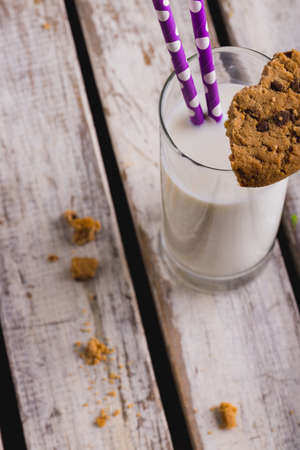 High angle view of milk glass with cookies on table, copy space. unaltered, food, drink and healthy food concept.の写真素材