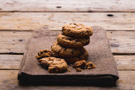 Cookies stacked on burlap at wooden table with copy space. unaltered, food, baked and snack.の写真素材