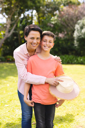 Caucasian mother and son spending time together in the garden. Family time spending outside ,...