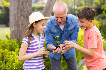Caucasian family spending time together in the garden, planting. Family time spending outside , garden, gardening, concept.の写真素材