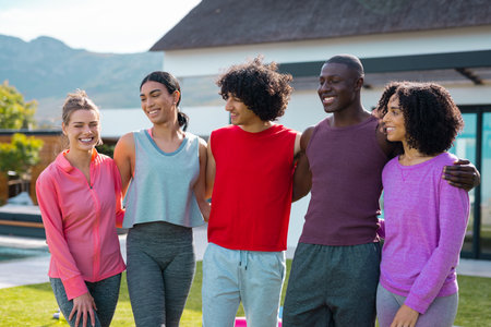 Happy diverse friends smiling and embracing in garden. Health, celebration, friendship, inclusivity and lifestyle concept.の写真素材