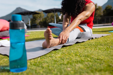 Diverse friends practicing yoga and stretching in garden. Health, celebration, friendship,...