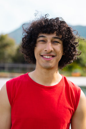 Portrait of happy biracial man smiling in garden. Health, celebration, friendship, inclusivity and lifestyle concept.の写真素材