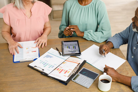 Senior diverse couple talking with african american female financial advisor. Finance, retirement...