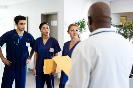 Diverse group of male and female doctors discussing in hospital corridor. Hospital, medical and...