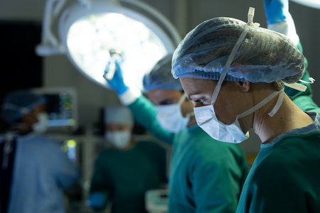 Caucasian female surgical tech and colleague adjusting lights in operating theatre, with copy space. Hospital, medical and healthcare services.の写真素材