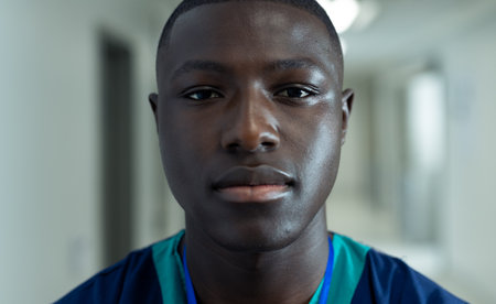 Portrait of african american male healthcare worker in hospital corridor, copy space. Hospital,...