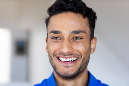 Close up of happy biracial man smiling and looking away. Relaxation, lifestyle and domestic life,...