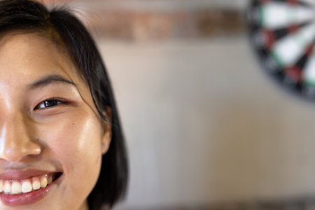 Half face portrait close up of happy asian casual businesswoman smiling, copy space. Casual office, confidence, business and work.の写真素材