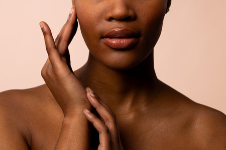Crop of african american woman with short hair touching hands and face. Femininity, face, facial...