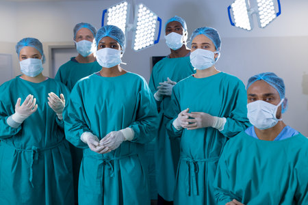 Portrait of diverse surgeons wearing surgical gowns in operating theatre at hospital. Hospital, surgery, hygiene, medicine, healthcare and work, unaltered.の写真素材