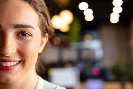 Half portrait of happy caucasian casual businesswoman in office with copy space. Casual office, business, lifestyle and work, unaltered.の写真素材