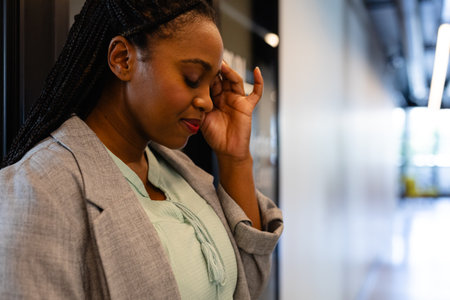 Profile of plus size african american casual businesswoman in office corridor. Casual office, business and work, unaltered.の写真素材