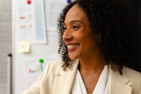 Happy african american casual businesswoman making presentation in office. Casual office, business, professional and work, unaltered.の写真素材