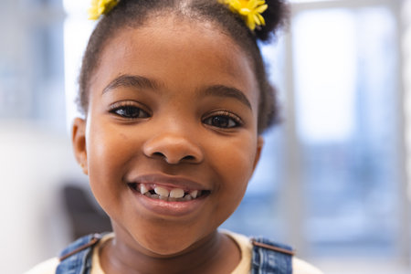 Portrait of happy african american girl patient in waiting room at hospital. Hospital, childhood,...