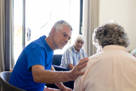 Senior diverse people sitting on chairs and talking in group therapy session. Senior lifestyle,...
