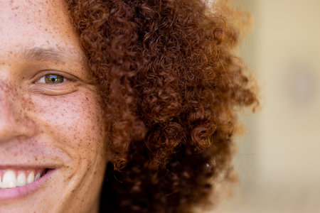 Portrait of happy biracial man looking at camera and smiling. Lifestyle, free time, happiness and domestic life, unaltered.の写真素材