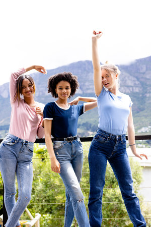 Image of three diverse women in t shirts with copyspace and denim trousers with nature background....