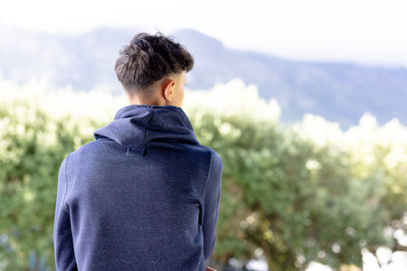 Image of biracial man in blue long sleeve hooded top with copyspace. Fashion, casual wear and nature...