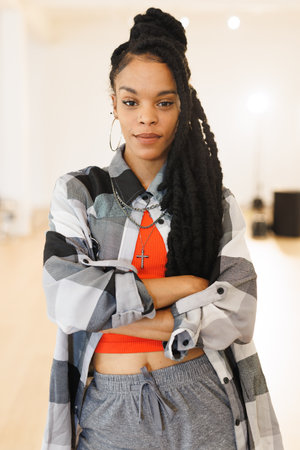 Vertical image of african american female hip hop dancer posing to camera. Dance, rhythm, movement...
