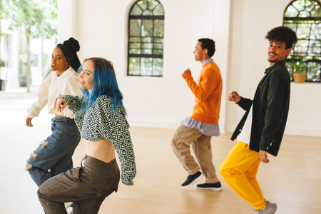 Image of diverse female and male hip hop dancers during training in dance club. Dance, rhythm,...