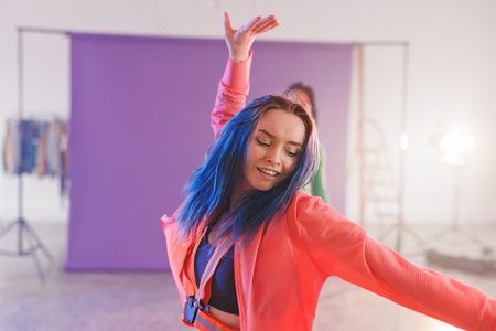 Image of happy caucasian female hip hop dancer in studio. Dance, rhythm, movement and training concept.の写真素材