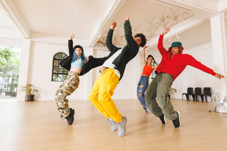 Image of group of group of diverse female and male hip hop dancers practicing in dance studio. Dance, rhythm, movement and training concept.の写真素材