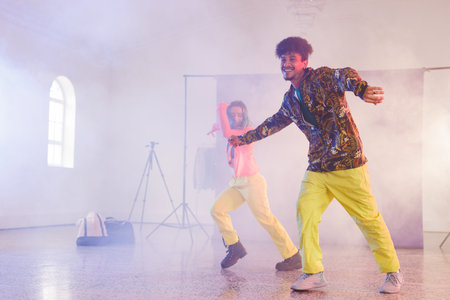 Image of happy diverse female and male hip hop dancers in studio. Dance, rhythm, movement and...