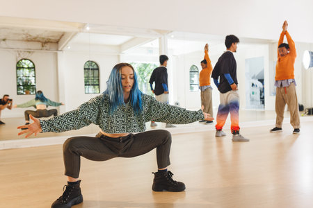 Image of diverse female and male hip hop dancers during training in dance school. Dance, rhythm,...