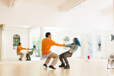 Image of diverse female and male hip hop dancers during training in dance club. Dance, rhythm,...