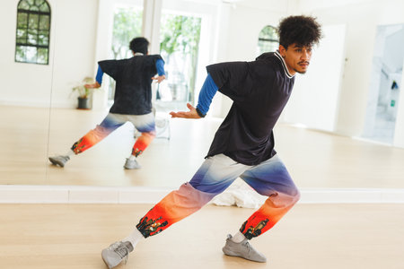 Image of biracial male hip hop dancer practicing at dance studio. Dance, rhythm, movement and...
