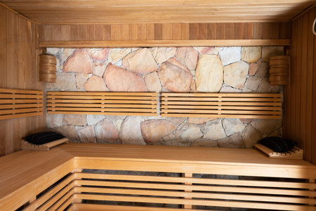 General view of sauna with wooden benches and stone wall. Spa, relaxation, beauty and lifestyle concept.の写真素材