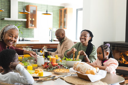 African american parents, children and grandparents celebrating at thanksgiving dinner, slow motion....