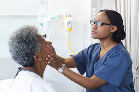 African american female doctor testing eyes of senior female patient in hospital room. Medicine, healthcare and medical services, unaltered.の写真素材