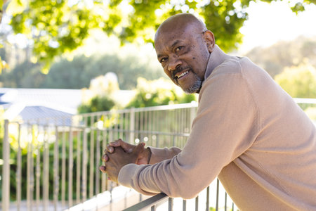 Portrait of african american senior man on sunny terrace. Lifestyle, retirement, senior lifestyle, nature and domestic life, unaltered.の写真素材